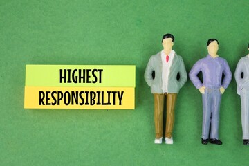 miniature people and colored paper with the word highest responsibility