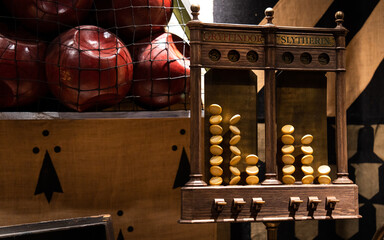 Naklejka premium JAPAN - NOV 13, 2023: A wooden house point scoreboard for Gryffindor and Slytherin with tokens and red balls in a net at The Making of Harry Potter, Warner Bros Studio Tour Tokyo, Japan