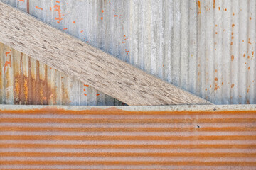 Wood of galvanized fence structure. Wooden structure background of rusted old metal sheet fence