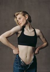 Fashionable and beautiful portraits of beautiful girl in jeans, short haircut and blonde hair