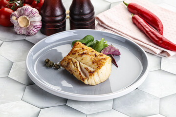 Roasted cod fish steak with salad