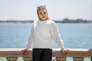 Mockup of a white sweatshirt on a girl in glasses, a pullover with slits on the sides, empty...