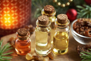 Christmas essential oils with frankincense, myrrh, spruce tree and candle