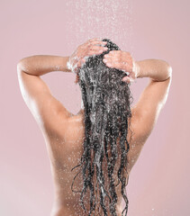 Woman, hair and shower or back in studio, pink background and relaxing for cleaning or model with...