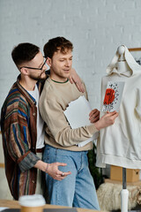 Two men, part of a gay couple, carefully study a fashionable shirt displayed on a mannequin.