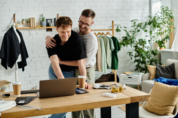 Two men passionately brainstorming at a laptop in a trendy designer workshop.