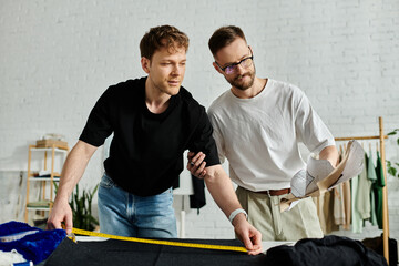 Two men, partners in design and in love, stand side by side in their trendy workshop.