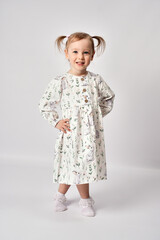 Full length portrait of cute little girl on a white background