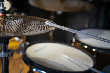 Close-up of drumsticks on drums in the hands of a drummer, selective focus