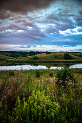 Obraz premium Landscape with river. Lake at the summer morning . Green forest . Golden sunlight . Reflections on the water . Fog on the water .
