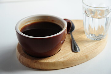 Delicious coffee in cup on light textured table, closeup