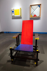 rietveld chair and paintings of de stijl on wall of centraal museum in utrecht