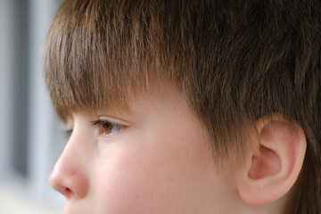 close up part child face, boy 8 years old, human eye looking to side, vision examination,...