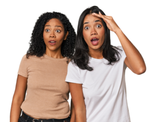 Young Latin friends in studio shouts loud, keeps eyes opened and hands tense.