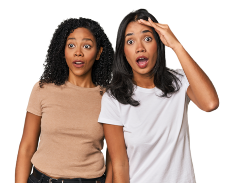 Young Latin friends in studio shouts loud, keeps eyes opened and hands tense.