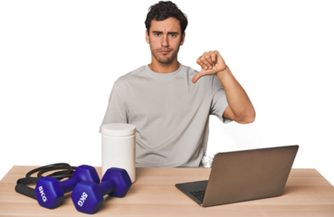 Hispanic trainer planning workout showing a dislike gesture, thumbs down. Disagreement concept.