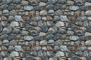 Obraz premium Rough stone wall texture creates a seamless pattern, ideal for rustic and rugged decorations. Perfect for architectural and natural concepts with a strong and durable feel.