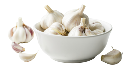 A white bowl filled with garlic bulbs sits next to two loose garlic cloves on a wooden surface
