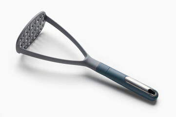 Plastic potato masher for making mashed potatoes. Kitchen utensils on white.