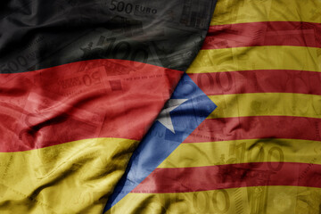 big waving realistic national flag of catalonia and national flag of germany on a euro money banknotes background. finance concept.