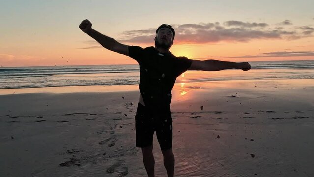 A man runs on the beach and does a backflip in slow motion in Morocco