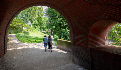 couple walks in park manenburg near old city center of utrecht in the netherlands