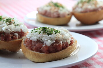 mettbrötchen with onions on wooden table