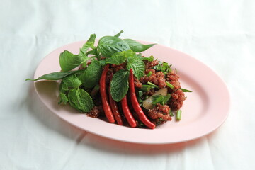 Thai food, Northeastern food, Larb Koi salad, raw beef salad. Northeastern Thai food. Raw meat mixed with spices has a spicy flavor with fresh blood and a bitter taste (called sok lek).