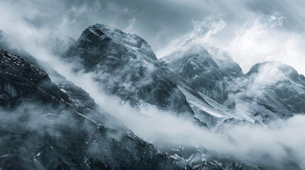 Misty mountain peaks. Dramatic image of snow-capped mountain peaks shrouded in mist, evoking a sense of mystery and adventure.