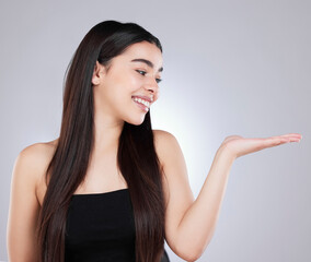 Fototapeta premium Portrait, studio and hand for woman and product placement, beauty and white background. Mock up, selfcare and cosmetic or dermatology, spa and salon treatment promotion or deal for female person