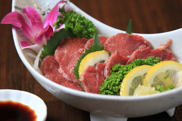 closeup of raw meat sliced  menu on a plate japanese style food