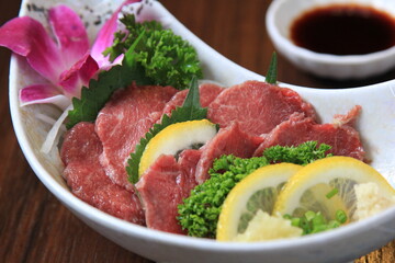 closeup of raw meat sliced  menu on a plate japanese style food