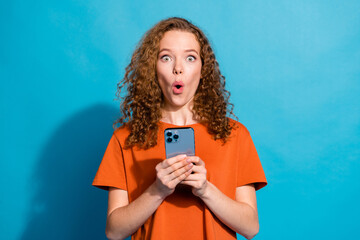 Photo of amazed girl hold use smart gadget isolated blue color background