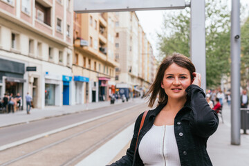 Fototapeta premium A tourist waits at a tram stop for the next train to arrive