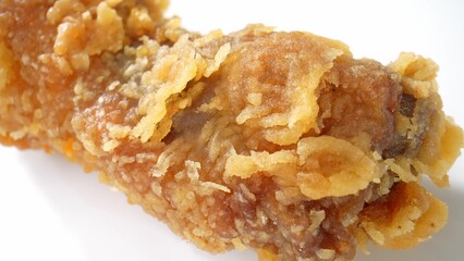 A tantalizing macro view showcases succulent hot fried chicken, the skin crackling, and spices enhancing its mouthwatering appeal. Processed food background. 

