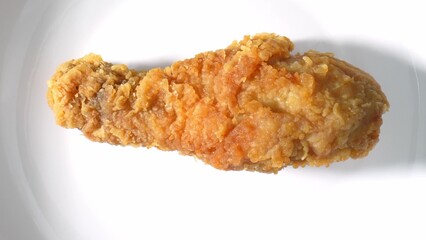 The fried chicken pieces reveal their intricacies - the delicate crackling of the skin, the...