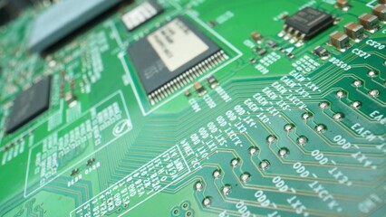 Explore intricate a Printed Circuit Board (PCB) designs through a mesmerizing macro lens, revealing the hidden world of electronic connections. Engineering concept.

