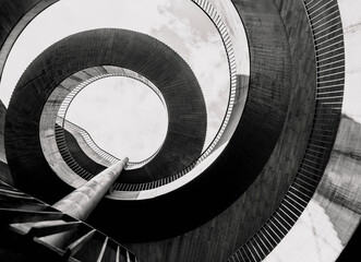 A modern geometric abstraction of curved and straight pieces of various materials, textures and sizes. Black and white photo