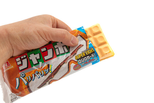 Fuji, Shizuoka, Japan - April 12, 2024: Hand holding Morinaga Choco Monaka Jumbo ice cream by MORINAGA & CO., LTD. Isolated on white background