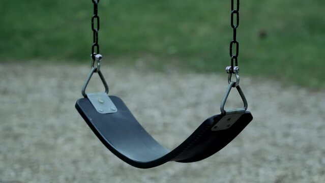 Detail shot of an empty playground swing