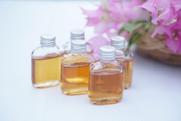 Transparent glass bottles of homemade herbal massage oil. Concept, Thai local wisdom to use fragrant medicinal herbs to make  massage oil for aromatherapy and relaxation.     