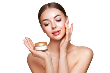 Beauty woman applying cream on her face. Young woman with clean fresh skin. Model with a jar of...