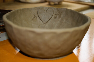 Handmade clay bowl with heart and initials carving