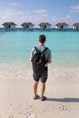 tourist in Maldives, beach holidays travel to Maldives remote island hotel resort, man standing on the beach
