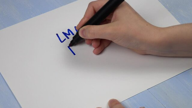 Young girl writes on a sheet of paper various words and expressions of gen z slang. Words &laquo;lmao", "rofl", "lol", "teehee", their meaning