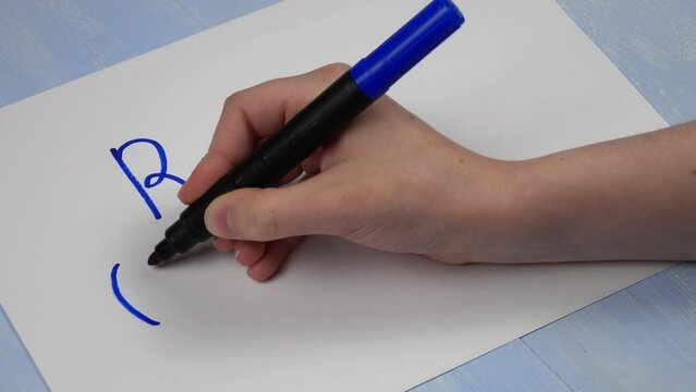 Young girl writes on a sheet of paper various words and expressions of gen z slang. Word &laquo;rofl", its definition and meaning