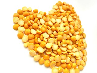Raw pieces of split peas on a bright background.