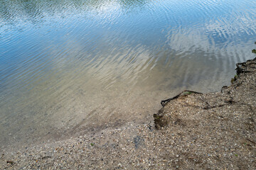 sandy pebbly shore on inland lake