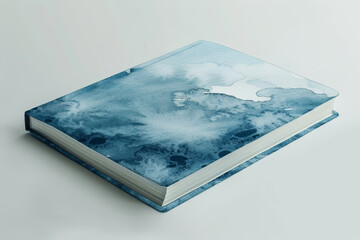 Blue watercolor cover book laying on white background, blending abstract art and literature, perfect for creative design concepts.