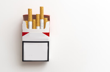 Open pack of cigarettes and a cigarette on a white background.